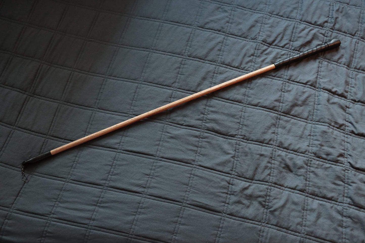 Full view of Deluxe cat wand toy with black leather handle and black leather-wrapped tip.