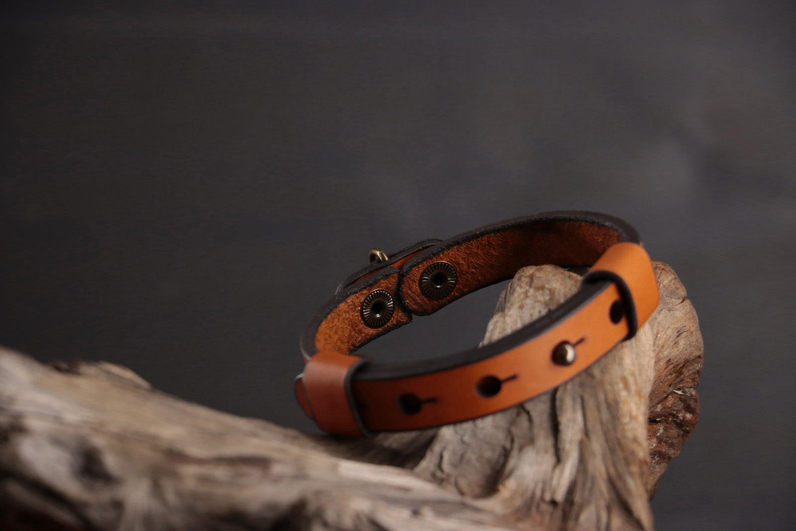 Back of cognac leather cat collar showing functionality of front snap closure.
