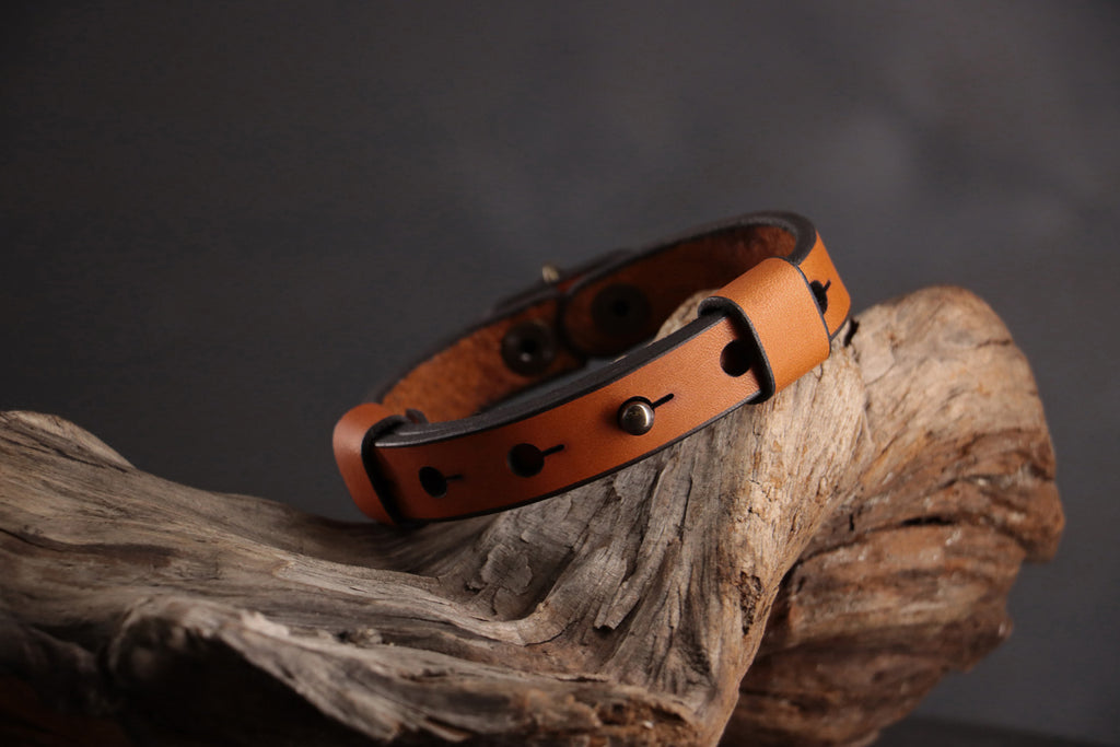 Back of cognac leather cat collar showing adjustable snap sizing system.