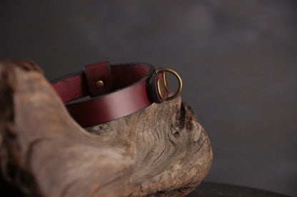 Side view of oxblood leather cat collar showing D-ring and snap closure.