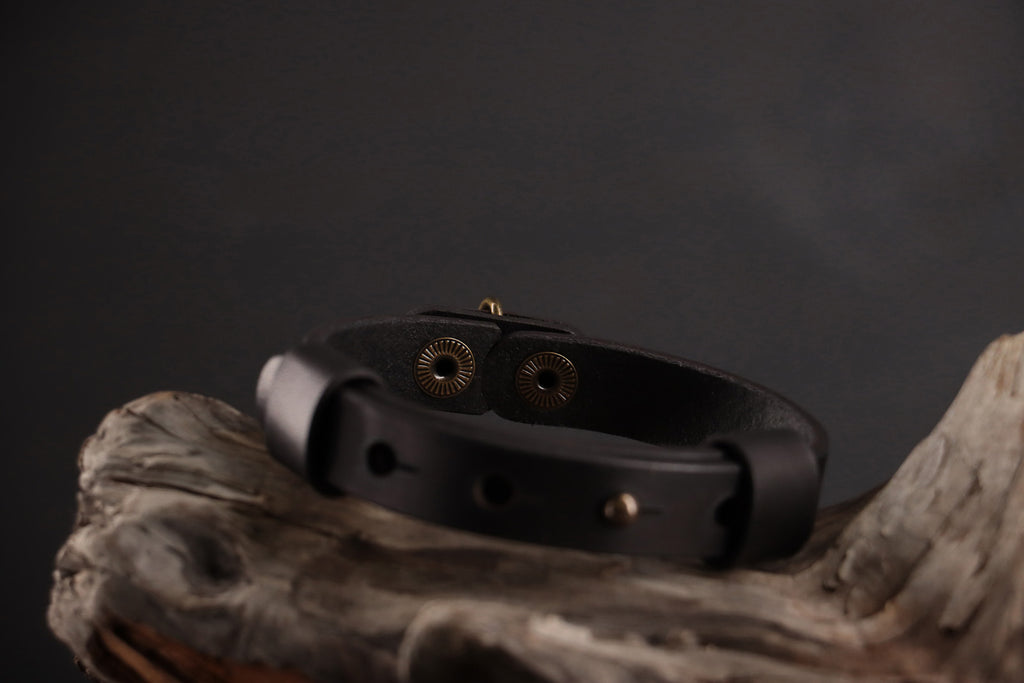 Back of black leather cat collar showing functionality of front snap closure.
