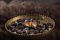Front of cognac leather cat ID tag charm with antique bronze D-ring.