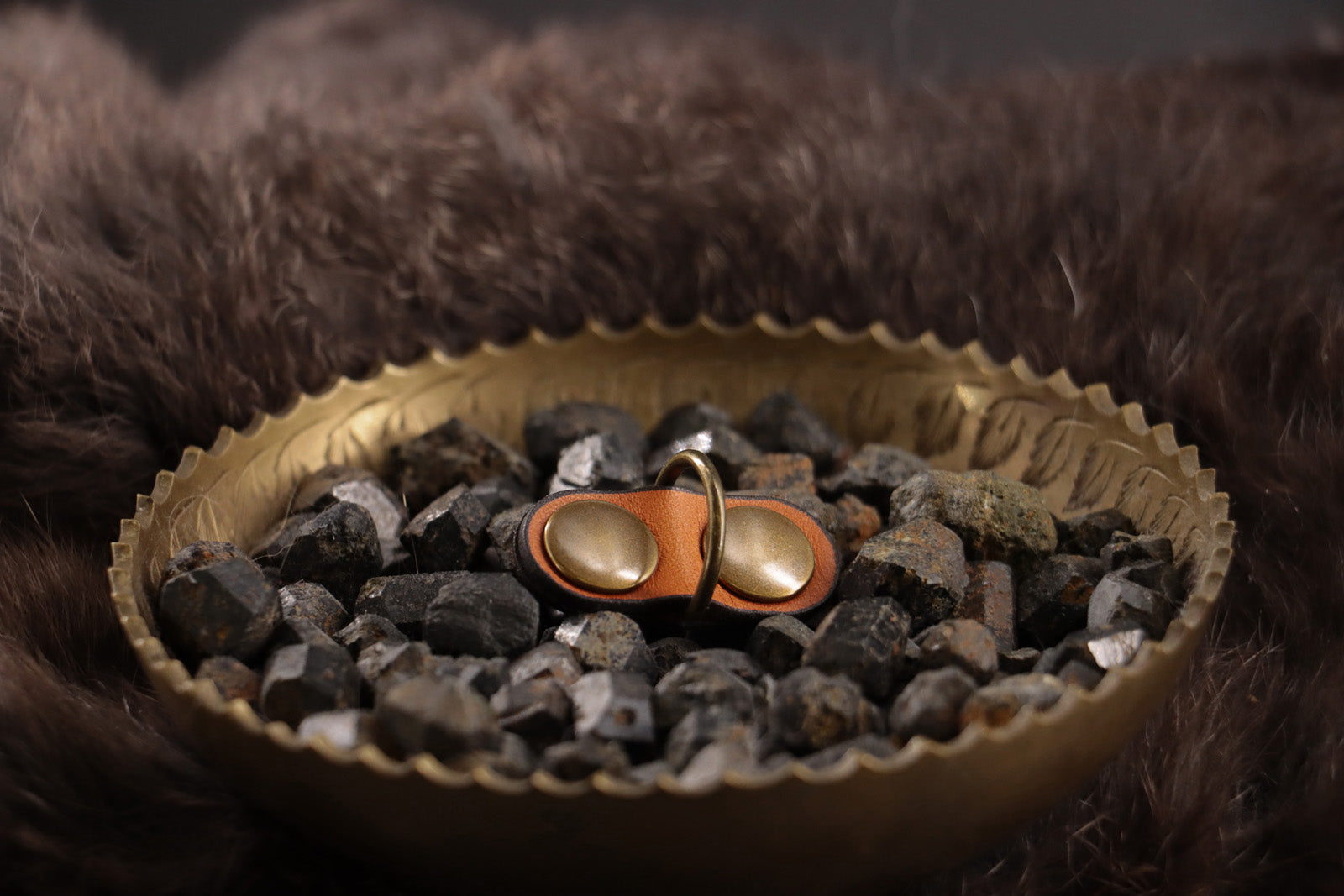Front of cognac leather cat ID tag charm with antique bronze D-ring.