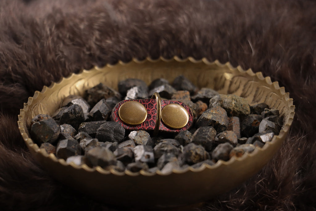 Front of red ostrich leather cat charm with antique bronze D-ring.