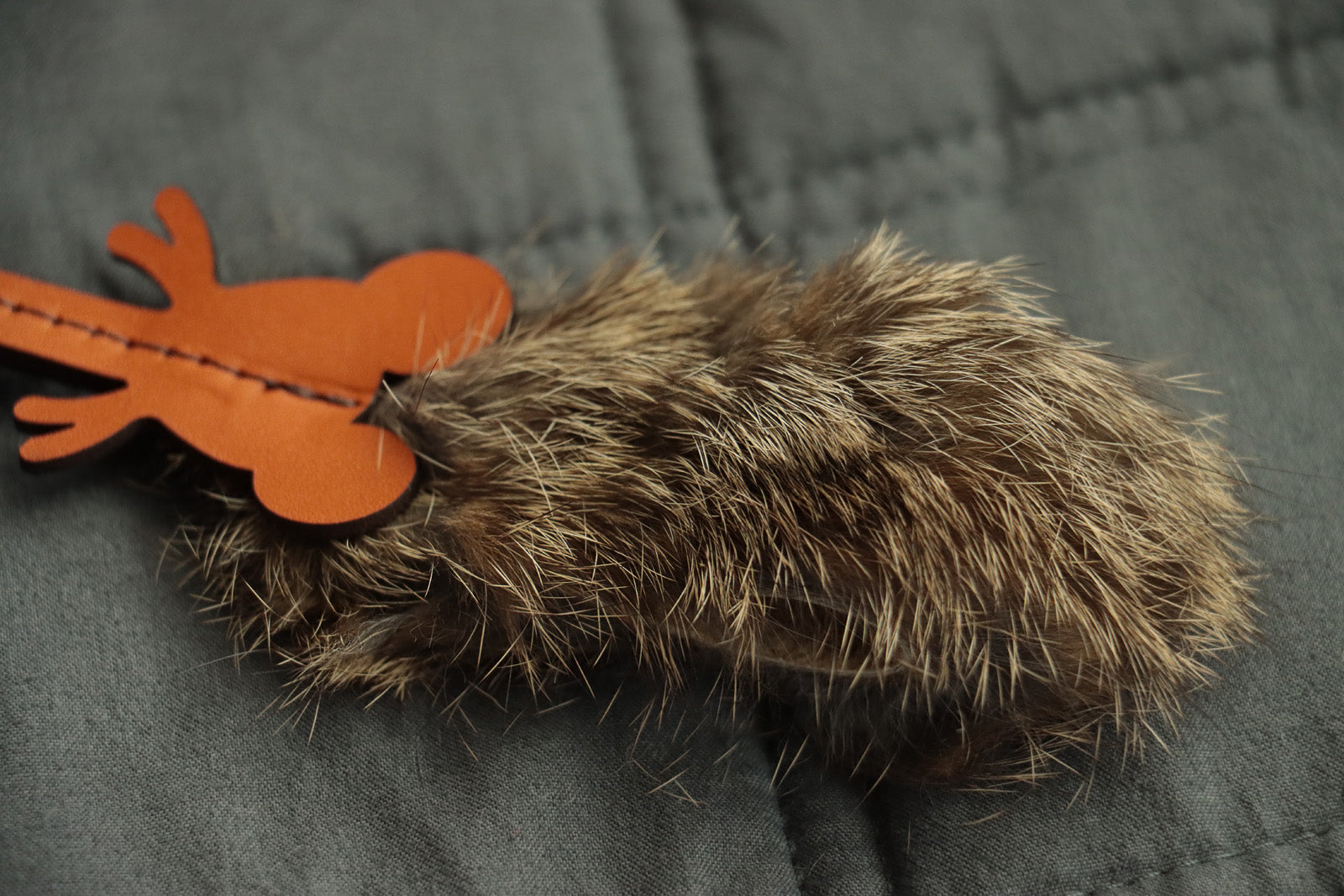 Handcrafted mouse cat toy with leather ears, whiskers, and fur body.