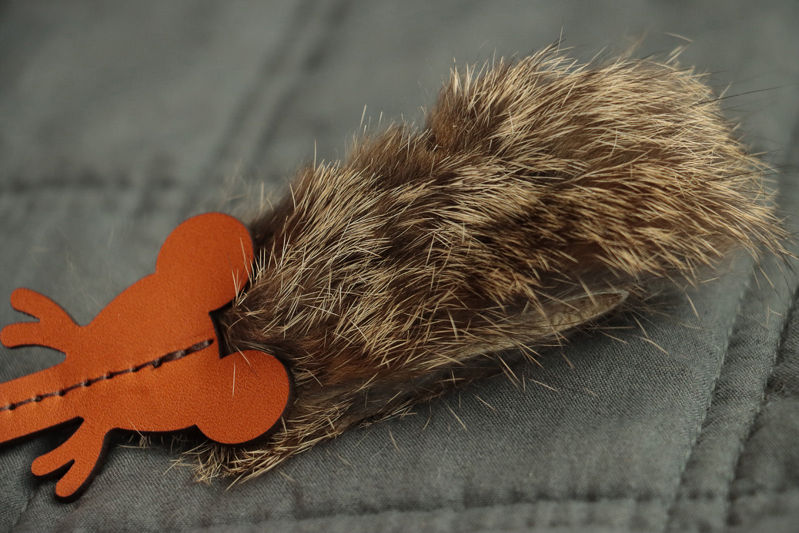 Handcrafted mouse cat toy with leather ears, whiskers, and fur body.